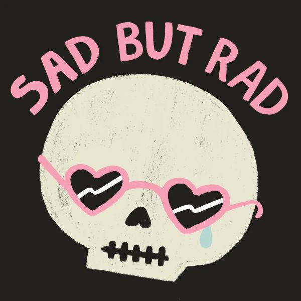A cartoon skull wears pink-framed, heart-shaped sunglasses with a single tear running down its left cheek. Above, a caption in pink text on the black background reads SAD BUT RAD.
