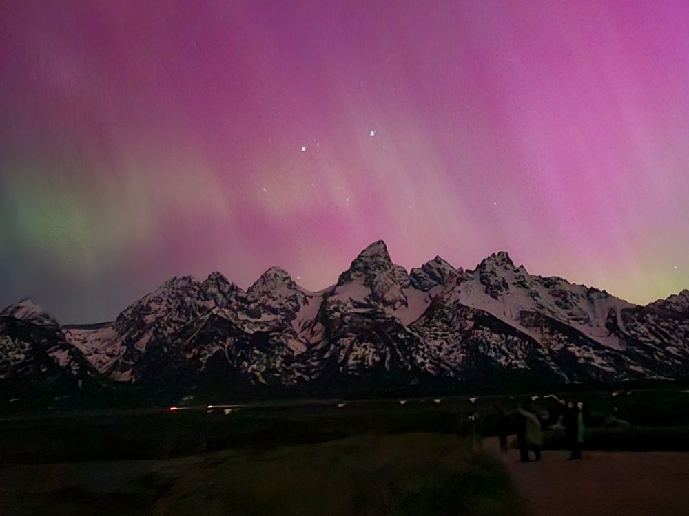 The Teton Mountains with purple and green aurora.