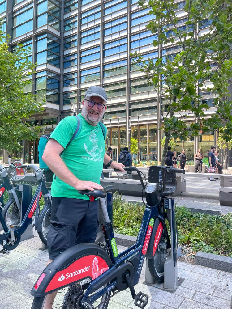 Photo of Chas Booth with a Santander e-bike in London. 