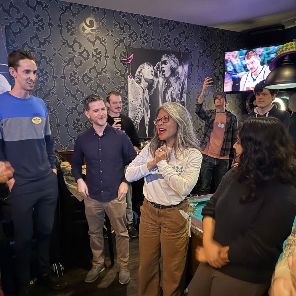 A group of YIMBYs at Fat Cat, with Alderwoman Hoppenworth giving a speech