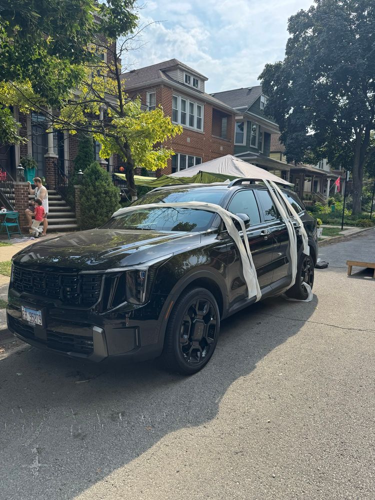 An SUV covered in toilet paper on the street