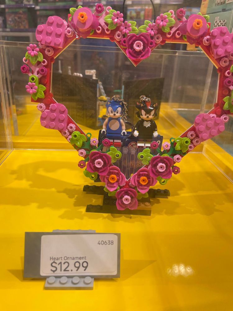 Sonic and Shadow LEGO minifigures surrounded by a pink flowery heart.