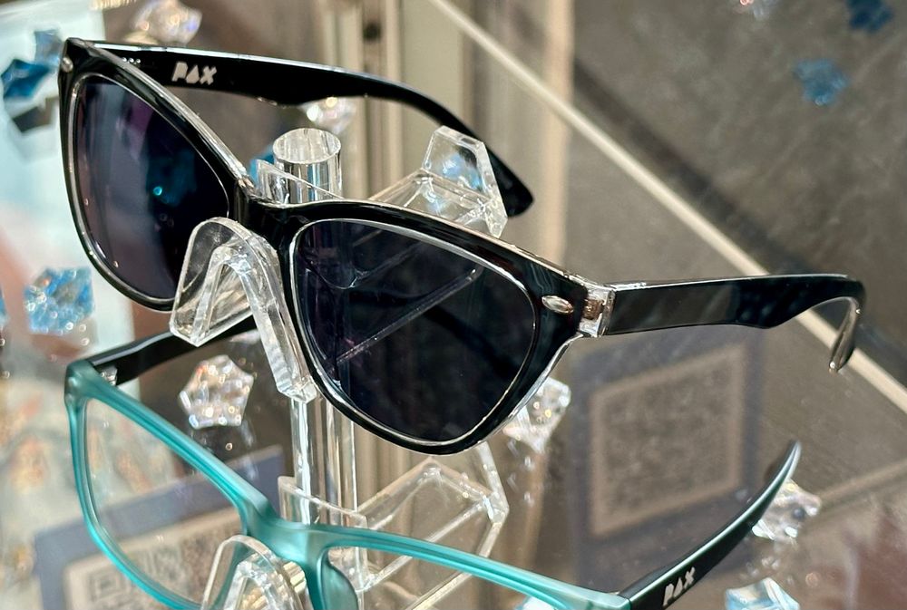 Just a photo of a pair of glasses in a jewel case. Logo printed on the inside is “PAX”