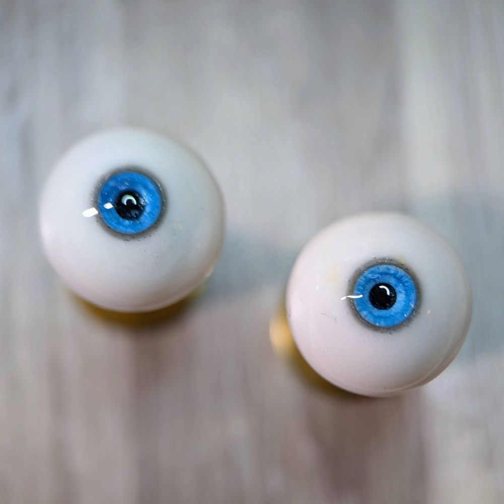 a pair of blue resin doll eyes