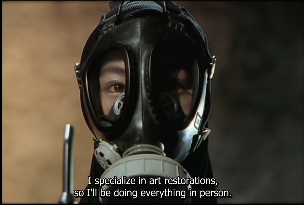 Sweet Home film still: A woman in a gas mask says "I specialize in art restorations, so I'll be doing everything in person"