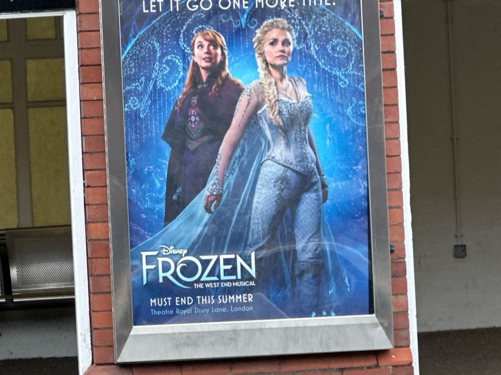A poster for Frozen: The West End Musical on a Tyne and Wear Metro platform, with a line stating “Must end this summer”