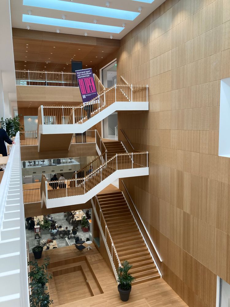 A stairwell with a banner with the text: Go open. Nobody learns from unfindable learning resources. 