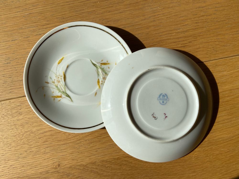 Two cute coffee saucers decorated with wheat spikes on the front, the back shows they were made in former Yugoslavia 