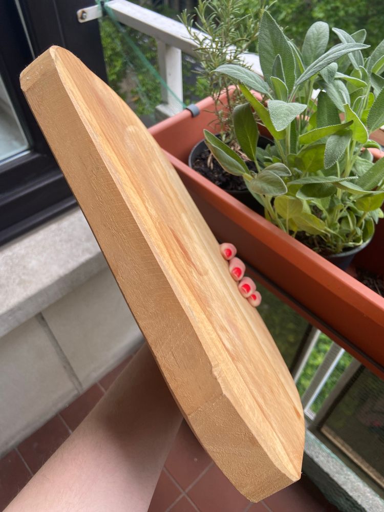 a nice wooden chopping board, found on the street, looks homemade, in this photo from the side 