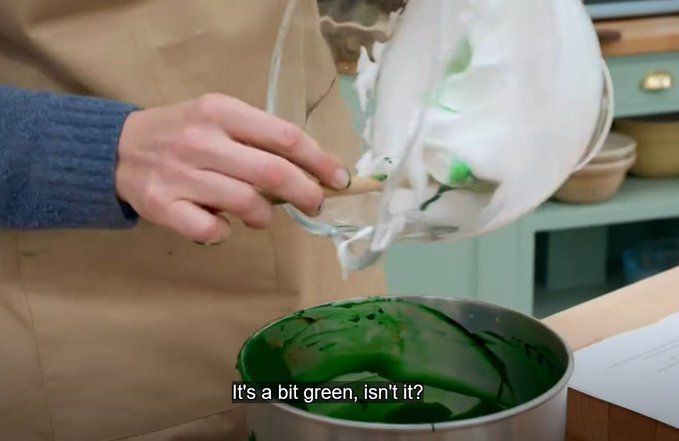 Bowl of batter that is noticeably verdant with the closed caption "It's a bit green, isn't it?"