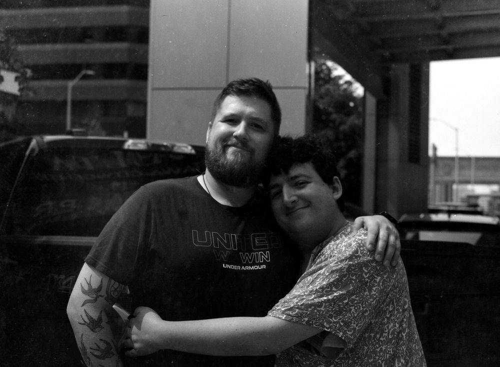 A full frame photo of the two of us embracing outside in black and white. 