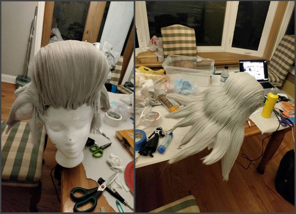Two progress photos of a helmet wig for a Dr. Xeno cosplay (from Dr. Stone). The first shows the wig from the front, emphasizing the size and shape of the pompadour. The second is a more birds-eye view of the top-back of the wig, showing how it splits into multiple points at the end. The wig rests on a white styrofoam head model, which rests on a messy table covered in craft supplies. A Dr. Xeno figurine, used as a reference, can also be seen.