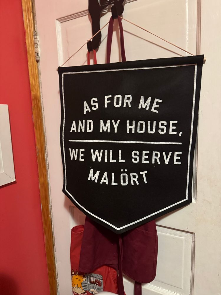 A banner that says “as for me and my house, we will serve malört” 