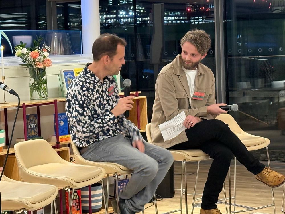 Me interviewing Adam Kay on slightly boyband-esque high stools. We look a bit like we could be doing a duet