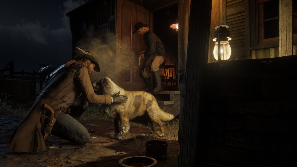 Arthur Morgan pets an Australian Shepherd in front of a small ranch home. The rancher is at the door with his gun drawn, clearly not pleased that Arthur is trespassing on his land and petting his dog, but that doesn't stop Arthur from petting them anyway.