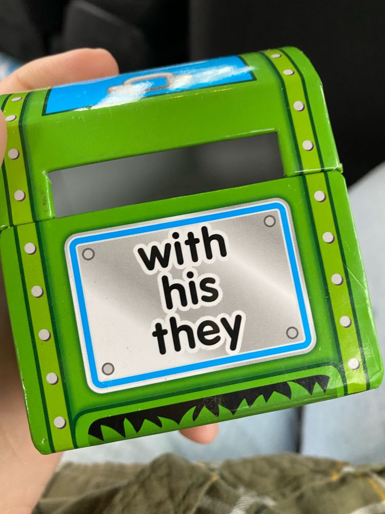 A little cardboard mailbox meant to put sight word cards into. On the front it says “with his they.”