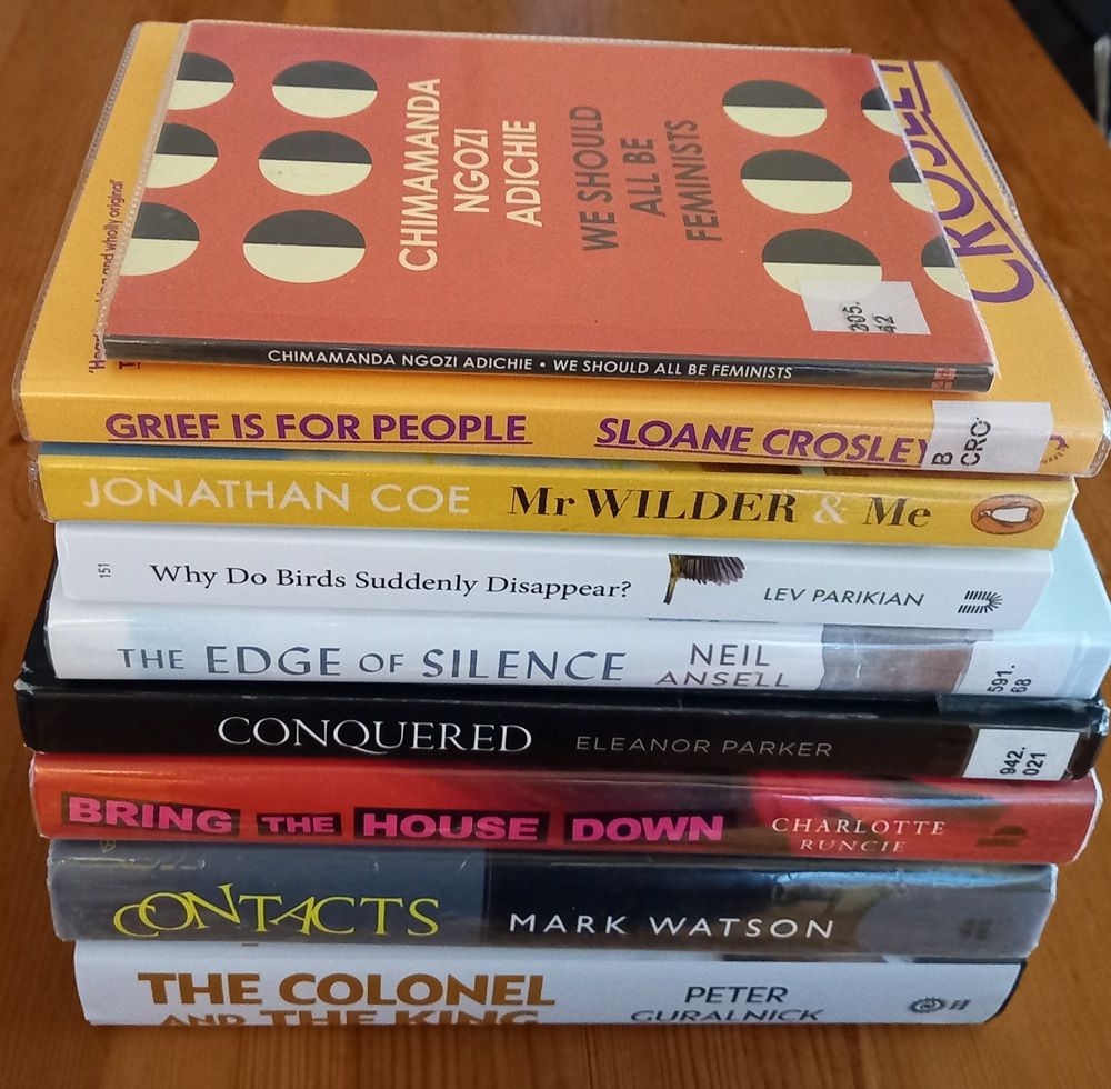 A pile of books: 'We should all be feminists' by Chimamanda Ngozi Adichie, 'Grief is for people' by Sloane Crosley, 'Mr Wilder and me' by Jonathan Coe, 'Why do birds suddenly disappear' by Lev Parikian, 'The edge of silence' by Neil Ansell, 'Conquered' by Eleanor Parker, 'Bring the house down' by Charlotte Runcie, 'Contacts' by Mark Watson, 'The Colonel and the King' by Peter Guralnick.