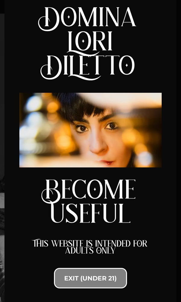 Screenshot of a black pop-up with white text that reads, “Domina Lori DiLetto: Become Useful” There is a photo of my brown staring through hanging gold lamps in the foreground.