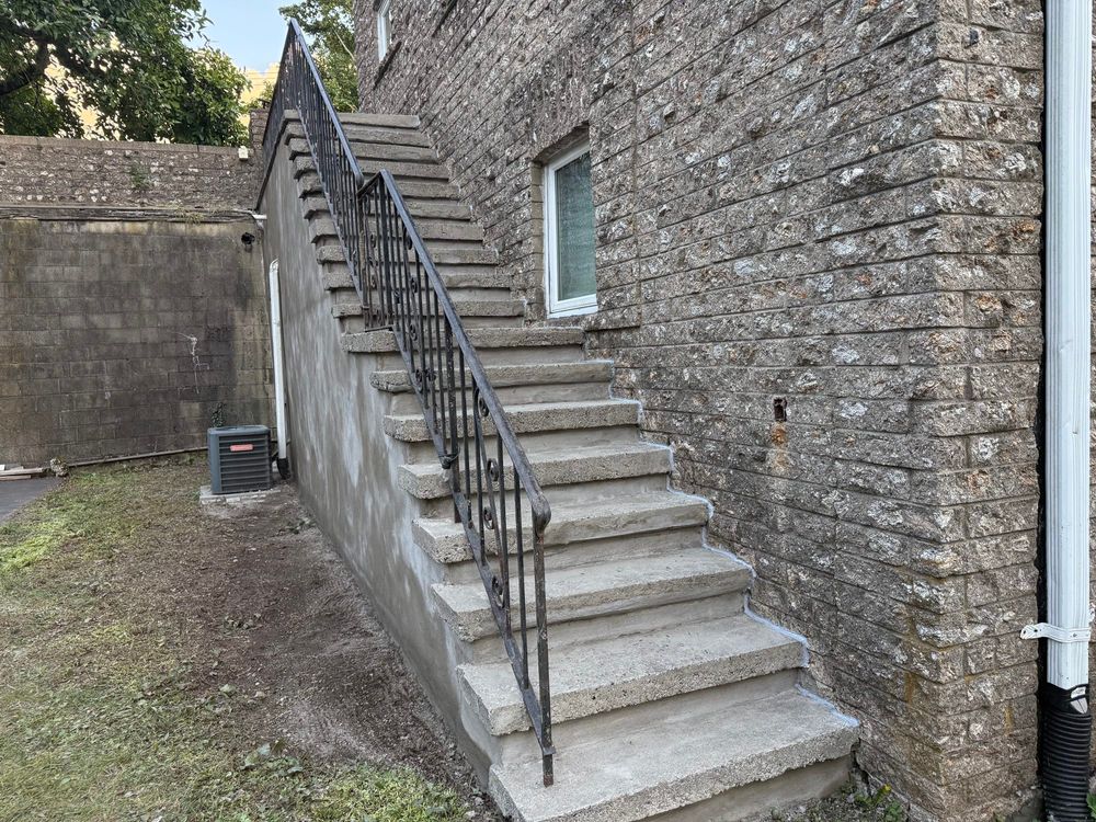 Concrete steps on the outside of my house, which is also a brick and concrete building looking very good
