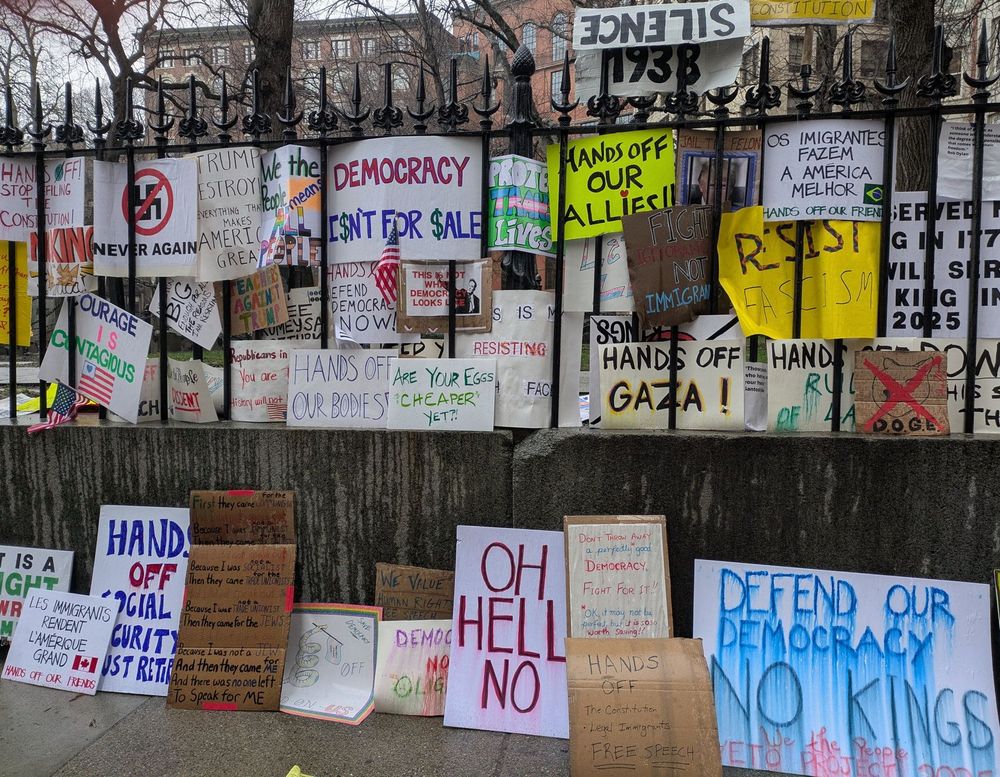 Many protest signs along the fence to the Granary Burying Ground