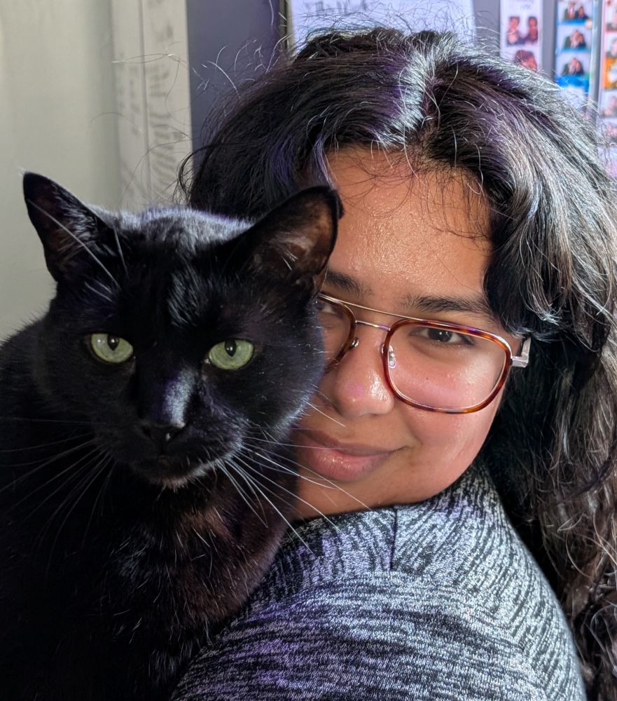 Picture of women holding black cat 