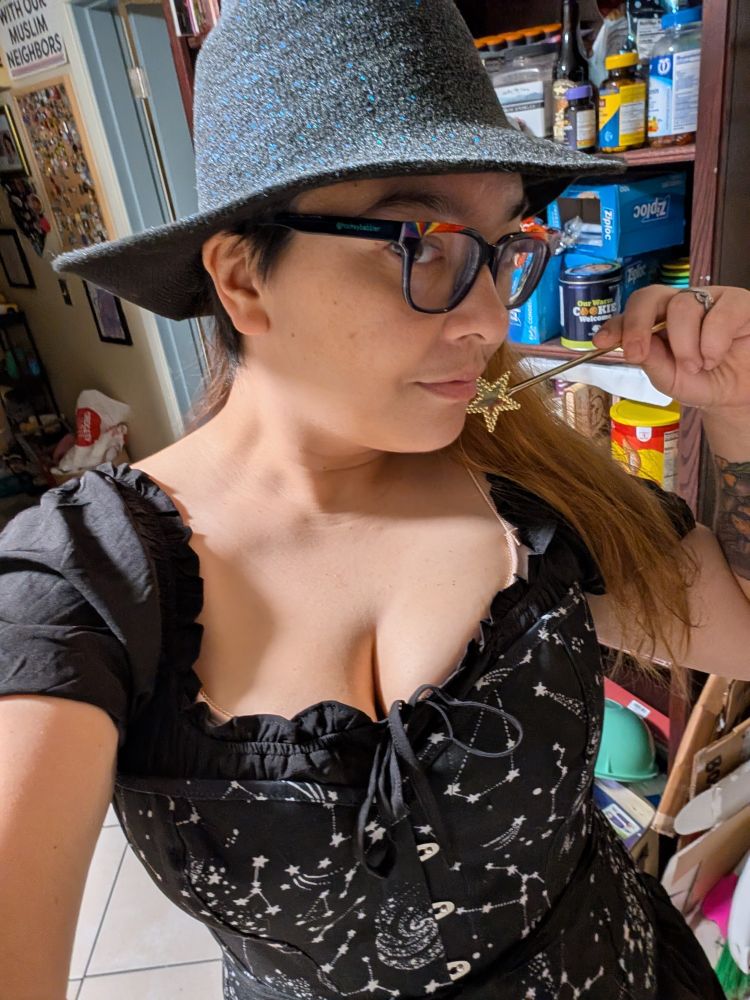 an enby femme dresses as a witch 