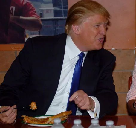 trump eating pizza with a fork