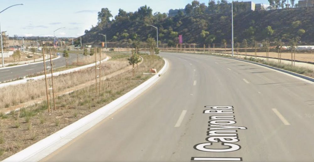 Carroll canyon road in Mira Mesa with a median that includes curbs and space for a transitway, currently filled with plants