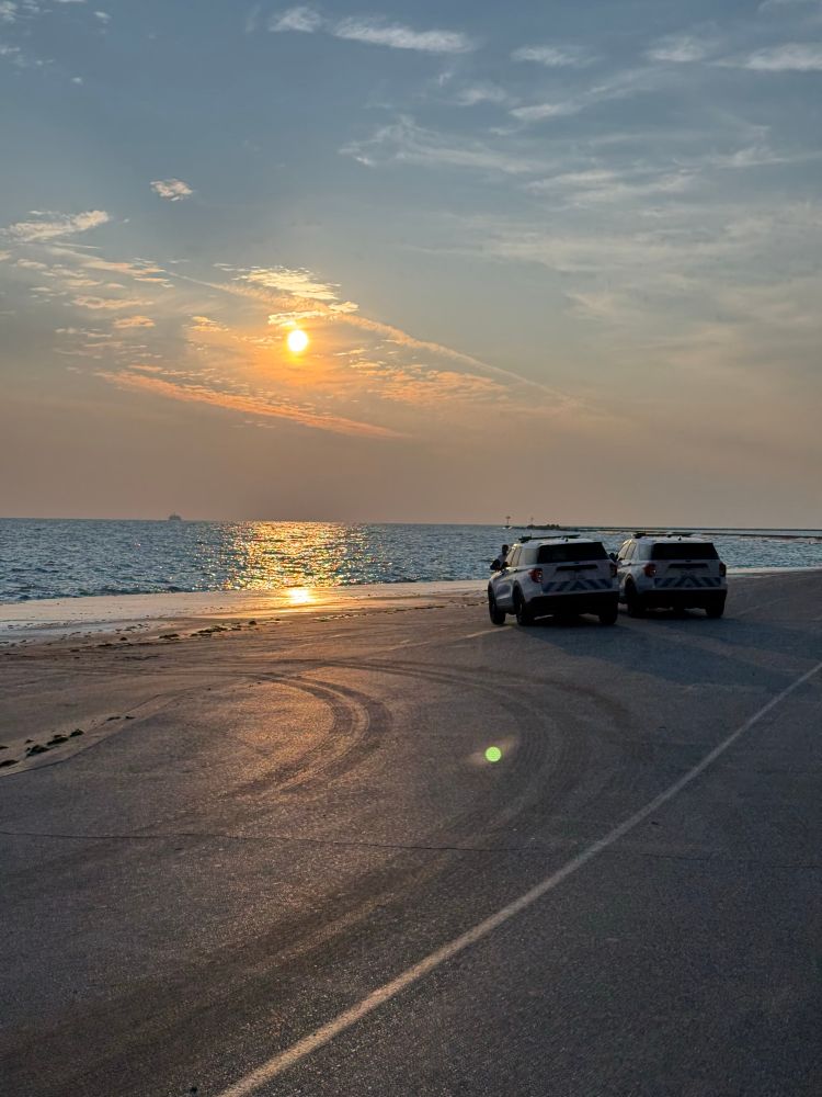 Two CPD Cruisers parked on the Lakefront Trail facing the sunrise