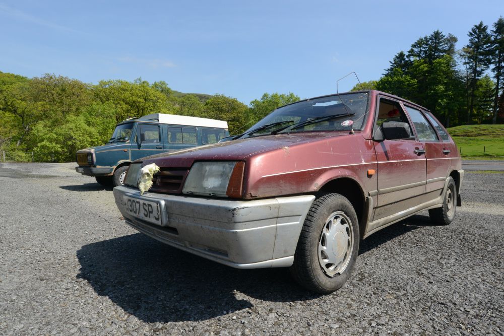 A scruffy Lada Samara in a car park. A Leyland Sherpa camper van is in the background.