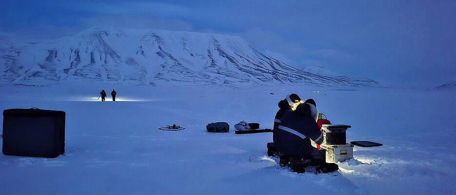 Researchers preparing a drone on Svalbard for flight.