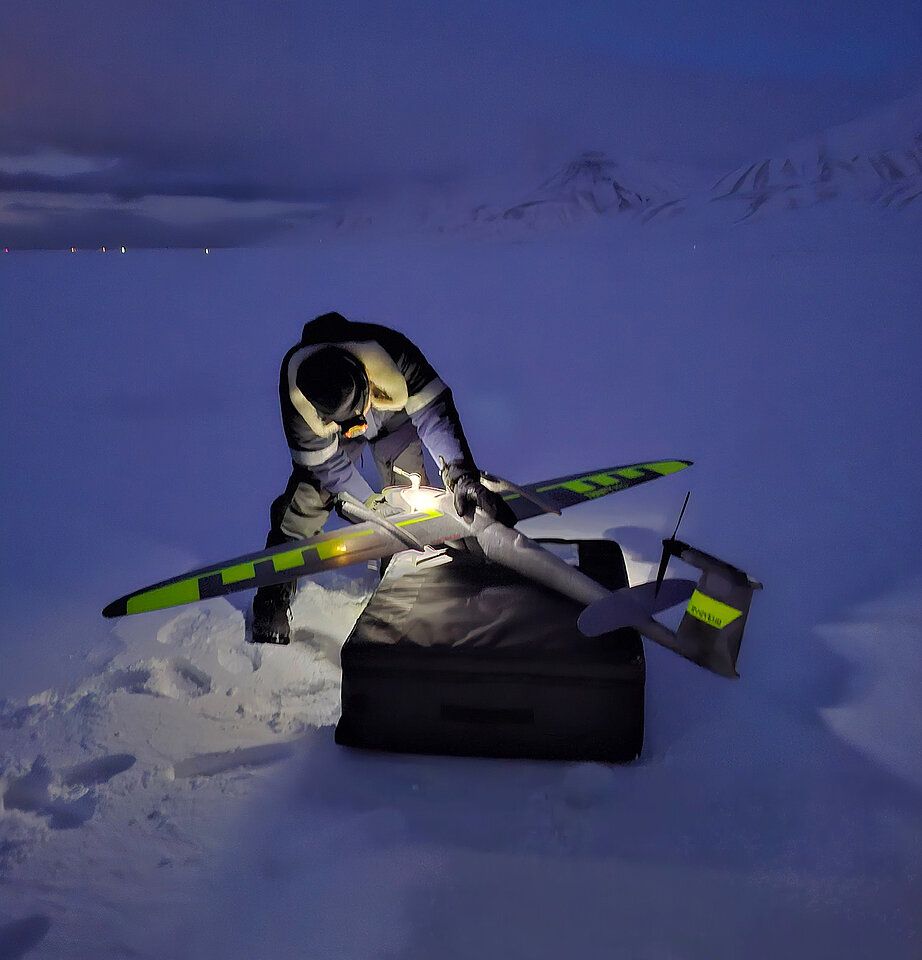 A researcher preparing a UAV/drone for an imaging mission on Svalbard.