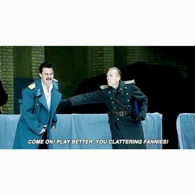 A still from the movie "The Death of Stalin" featuring Rupert Friend as Vasily yelling "come on! Play better, you clattering fannies" at the ice hockey team he's meant to be coaching 