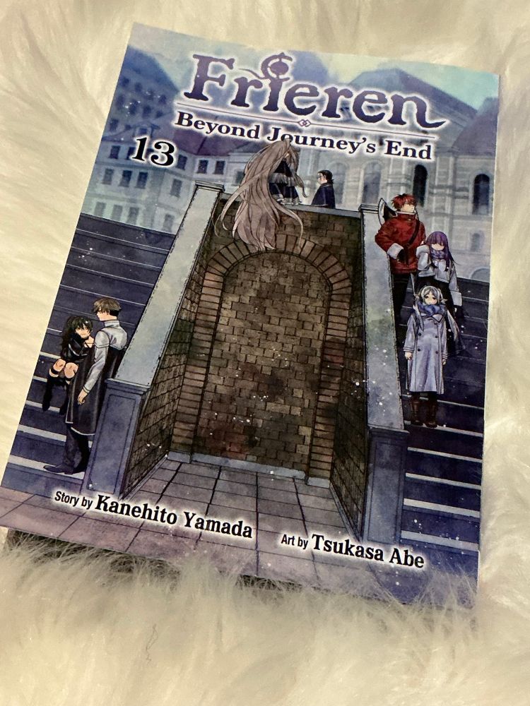 The manga cover to Frieren 13
All 7 characters are in the book.
Interesting them set on the stairs going around.