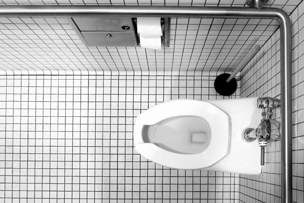 A photo looking down at a handicap assessable toilet in a public bathroom.  
