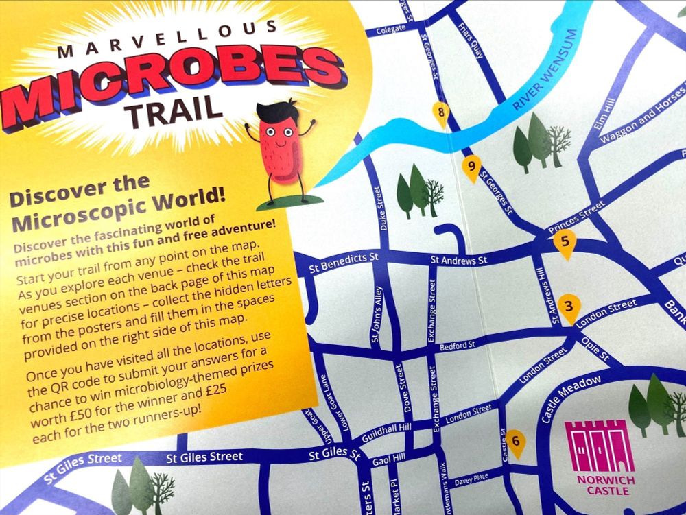 A photo of the Marvellous Microbes trail map which includes the streets of Norwich with pins showing different locations of posters. There is text which mentions that by completing the trail you can submit your answers for a chance to win microbiology themed prizes worth £50 for the winner and £25 for the two runners up!