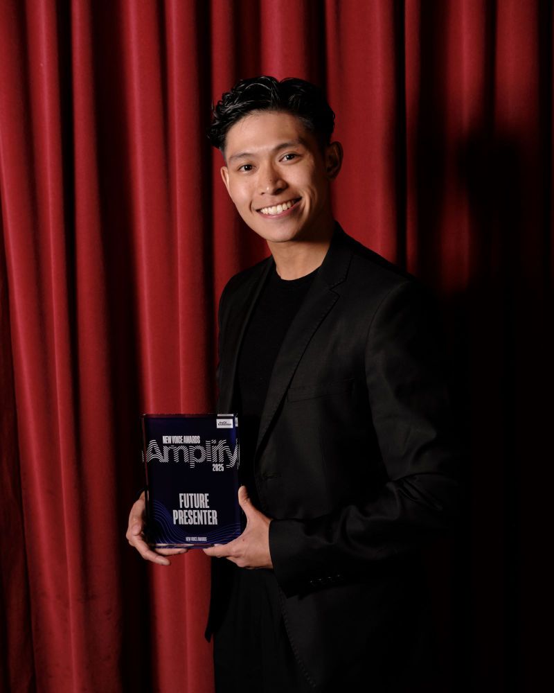 Gabriel Astorga holding the Amplify award