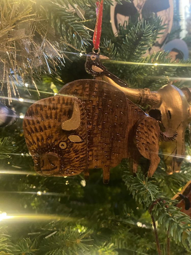 closeup of a handmade wooden bison ornament 