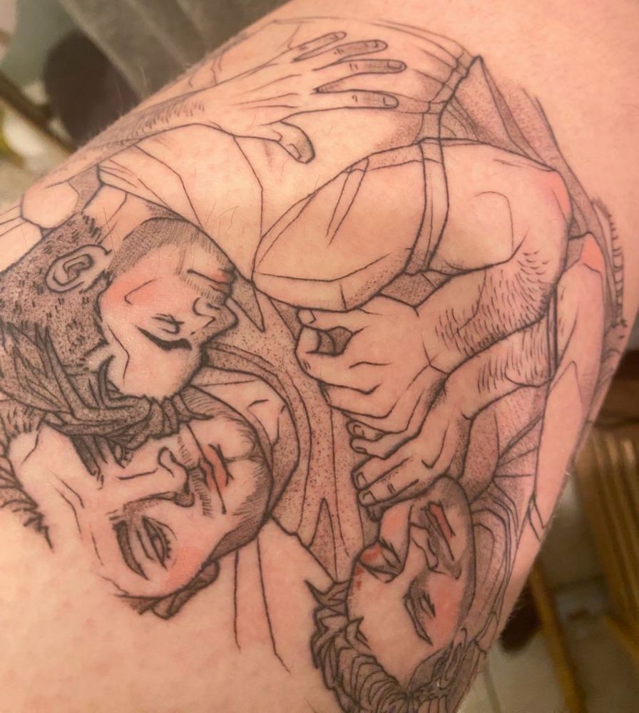 closeup of a black and white polyfire tattoo, with pink accents. 