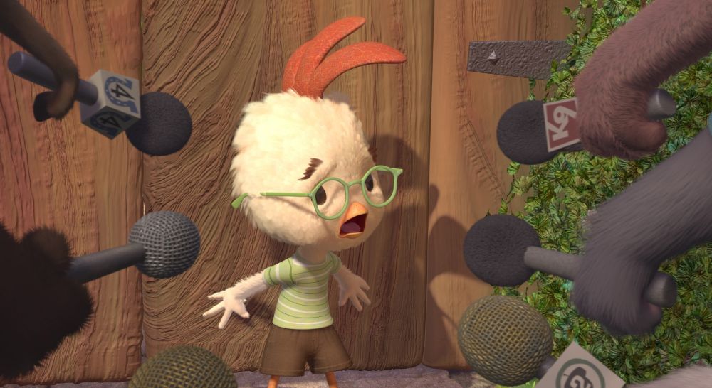 Chicken Little in a state of panic as he is surrounded by many people with microphones. Chicken Little (2005).