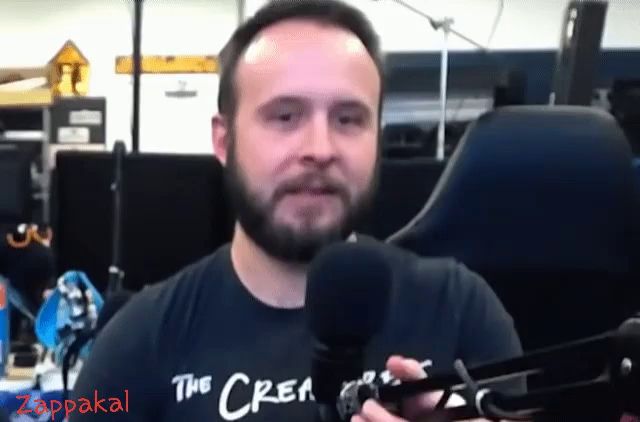 a man with a beard is wearing a shirt that says " the crea "