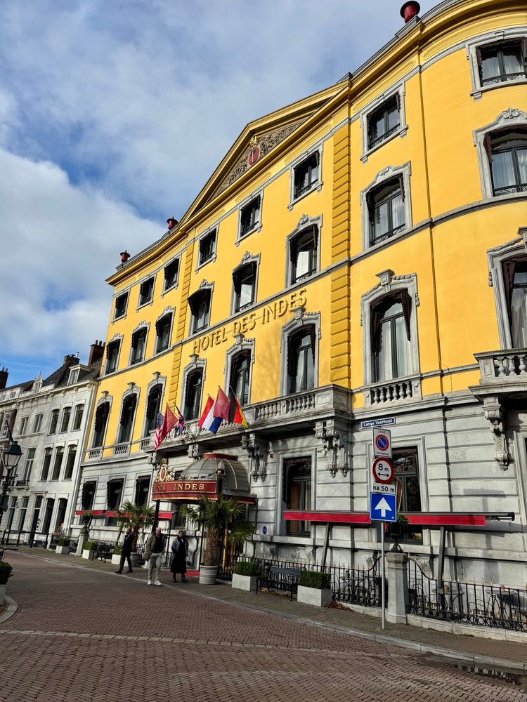 The Hotel Des Indes a historical hotel in the centre of the Hague. It is bright yellow.