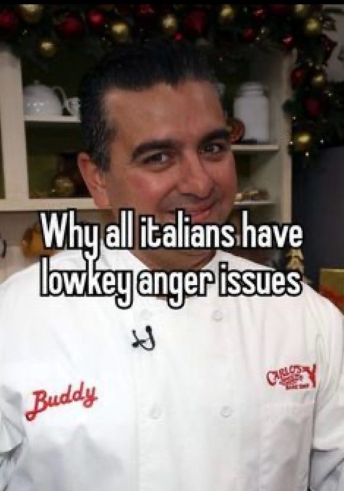 Buddy the baker from cake boss wearing his white baker’s jacket with his name in red on the left side of his chest and Carlos Bake Shop in red on the right side of his chest. There are white words outlined in black over his picture that read “Why all Italians have lowkey anger issues”.  