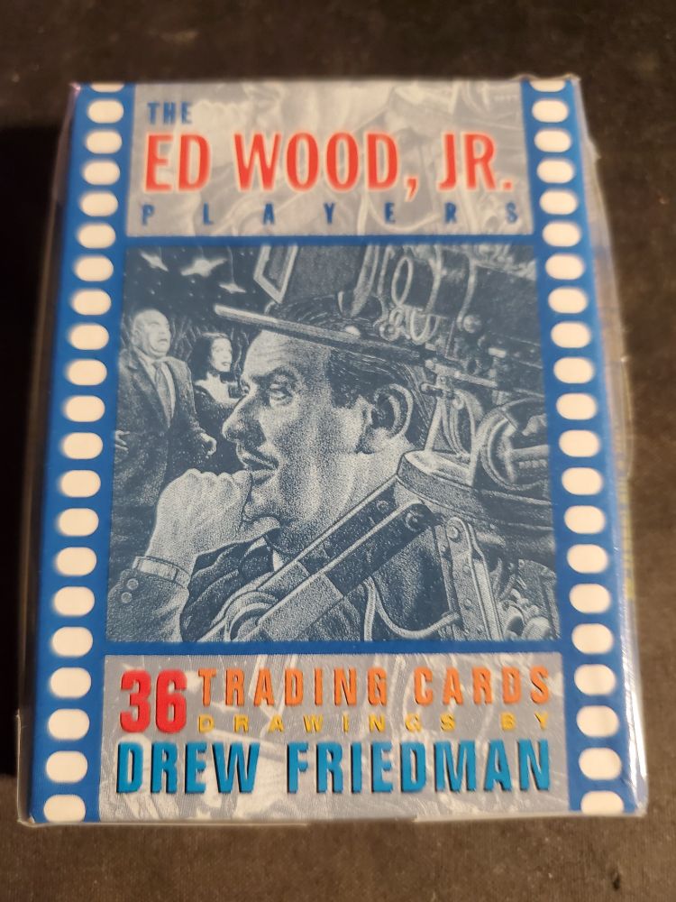 The Ed Wood Jr. Players trading card set illustrated by Drew Friedman second edition 
The box is blue and looks like a filmstrip with an illustration of Ed Wood directing Plan 9 From Outer Space