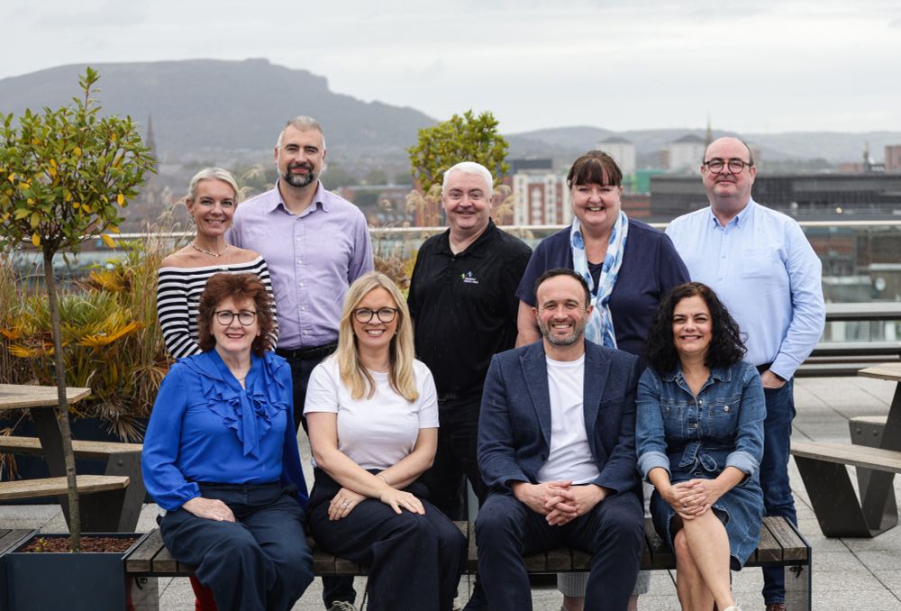 Photo of some of NICVA's Executive Committee pictured together on a rooftop overlooking Belfast.