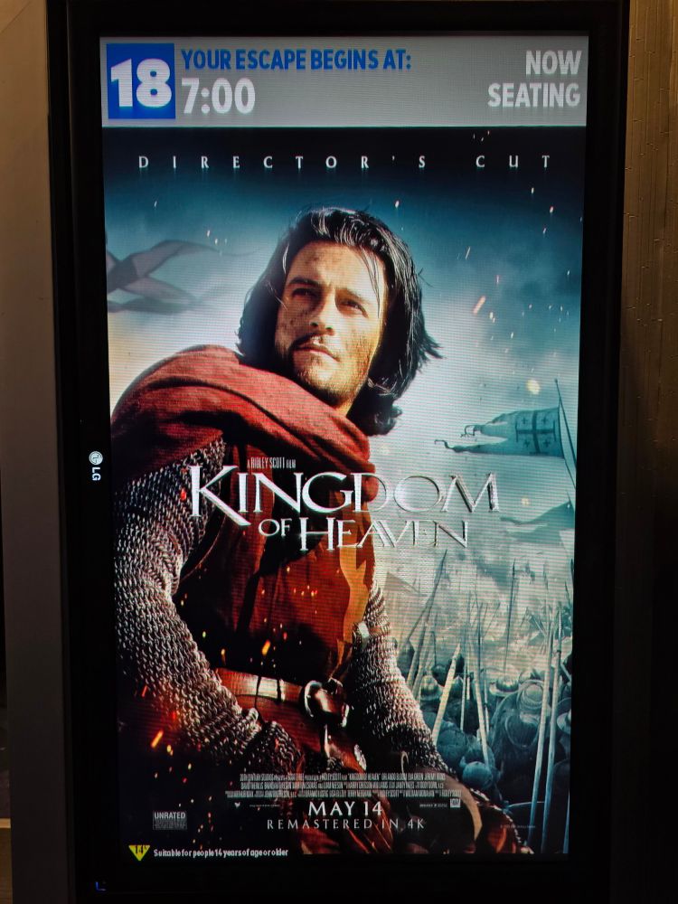 Kingdom of Heaven Director's Cut movie poster displayed on a poster-sized digital screen with the showtime of 7pm above it.