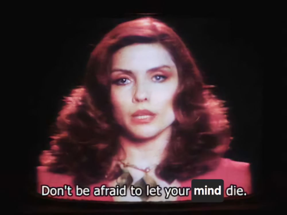 Edited screencap from Videodrome of Debbie Harry's character on a TV screen saying "Don't be afraid to let your mind die"