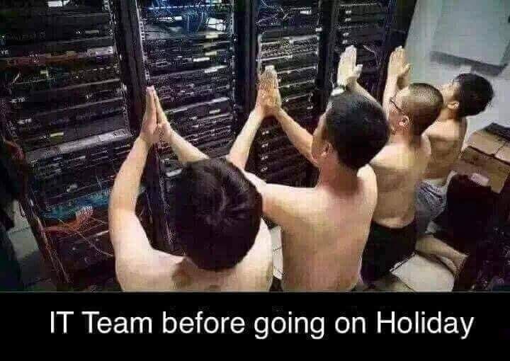 A group of half naked men pray in front of a server rack