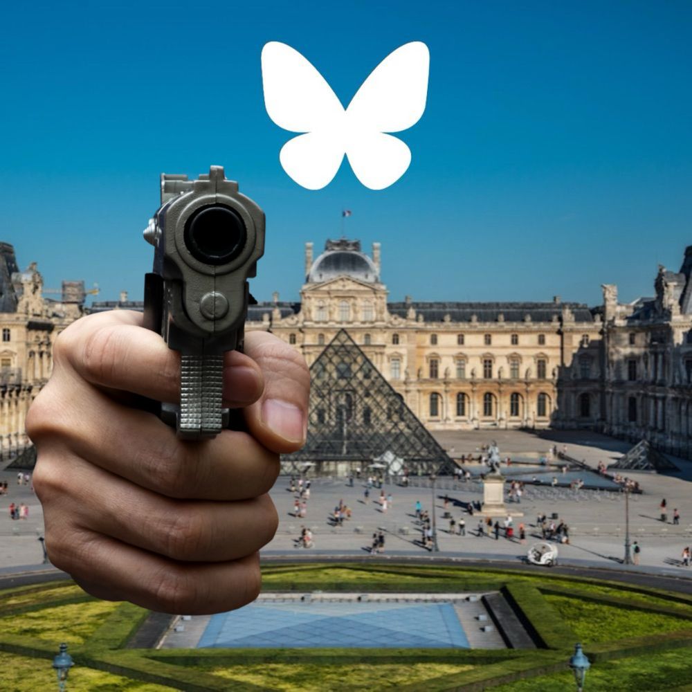 The Louvre with a hand holding a gun at you