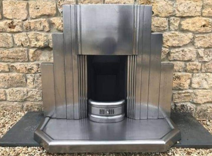 A salvaged 1930s Art Deco polished steel fireplace and surround, courtesy of Edward Elderman, USA, on X.